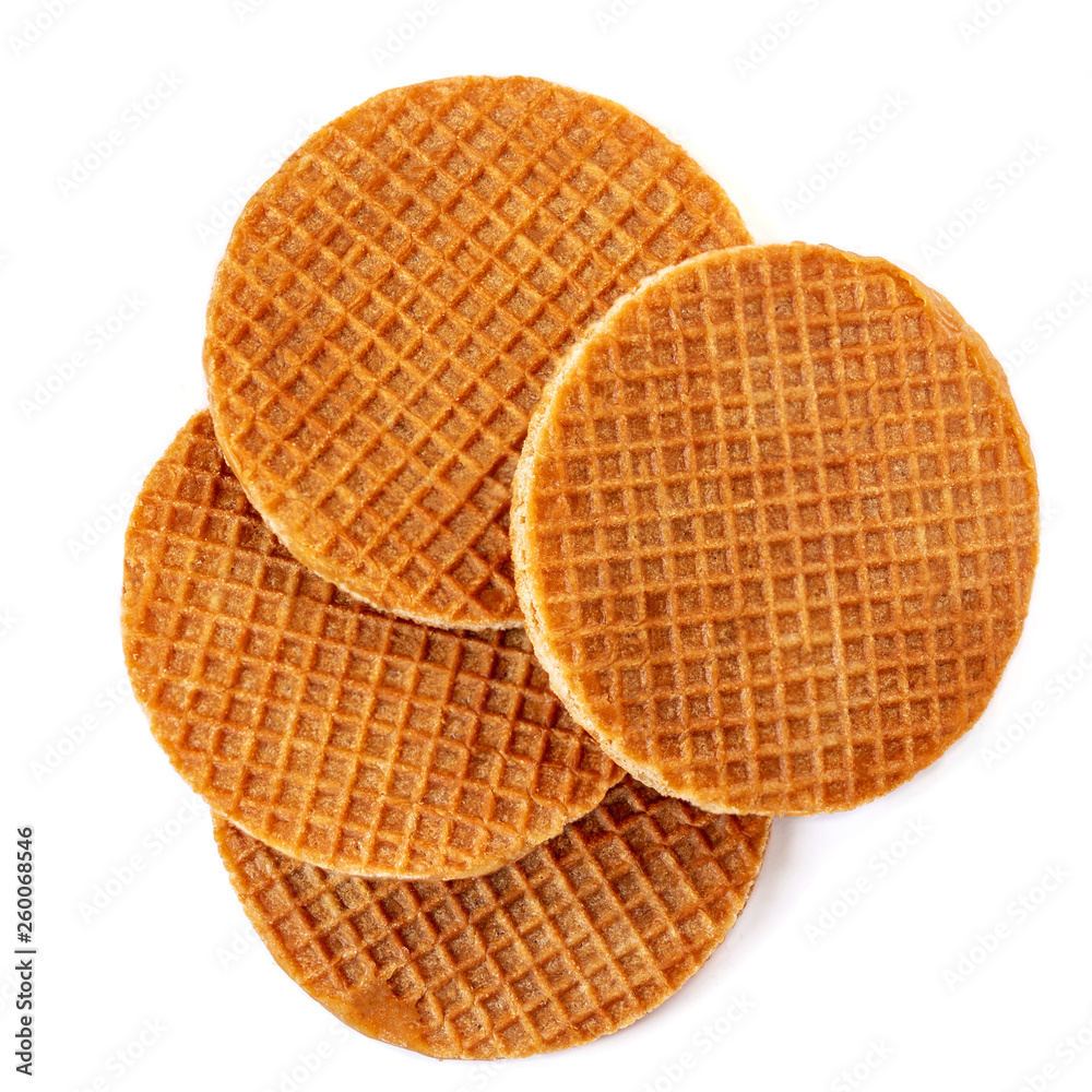 Pile of caramel  round Dutch waffles isolated on white background. Top view