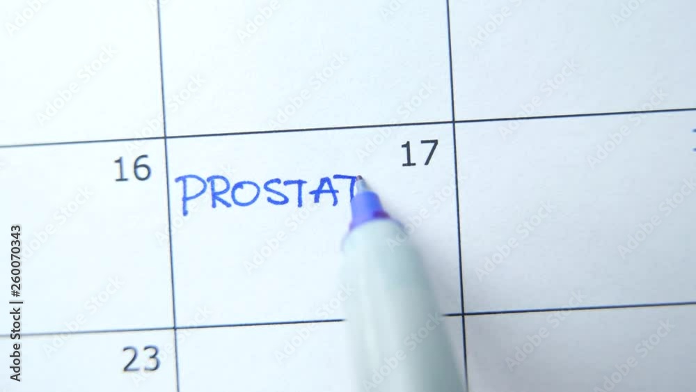 Closeup on a calendar with PROSTATE EXAM being marked by a marker Closeup on a calendar with PROSTATE EXAM being marked by a marker