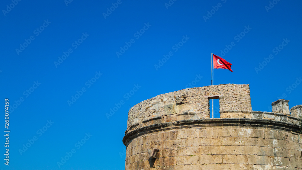 Hidirlik Tower with the turkish flag waving on the wind. Shoot in Antaya, Turkey.