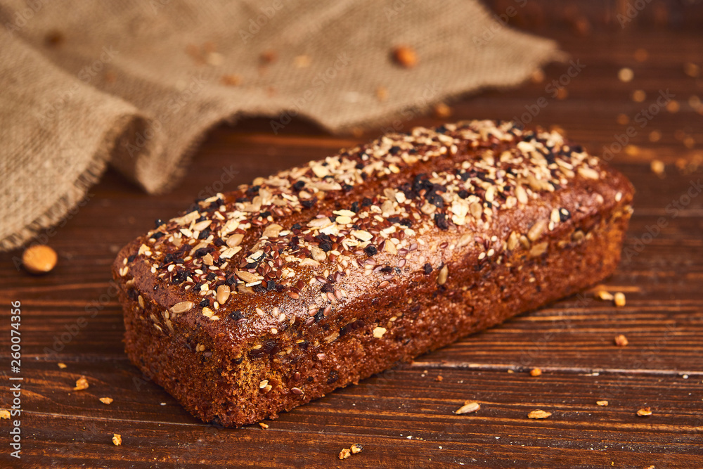 Whole wheat craft bread on wooden background. The concept of healthy food and traditional bakery. Rustic Whole wheat craft bread on wooden background. The concept of healthy food and traditional bakery. Rustic
