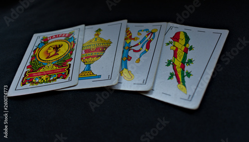 Spanish playing card, aces of golds, cups, swords and maces one behind another