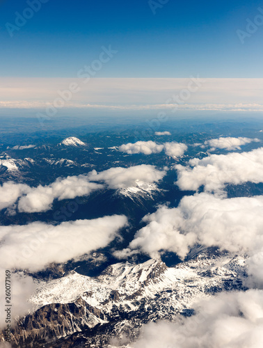 Quadro su tela beautiful clouds from above with sow covered mountains