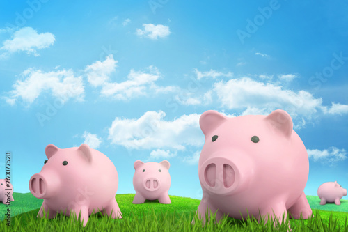 3d rendering of several pink piggy banks on green sunlit meadow under blue sky with white clouds.