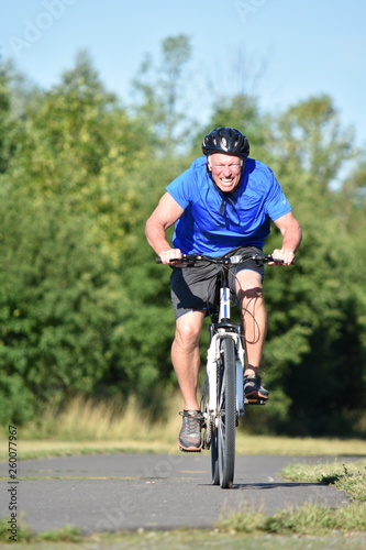 Fototapeta Naklejka Na Ścianę i Meble -  Stressful Male Cyclist Wearing Helmet Biking