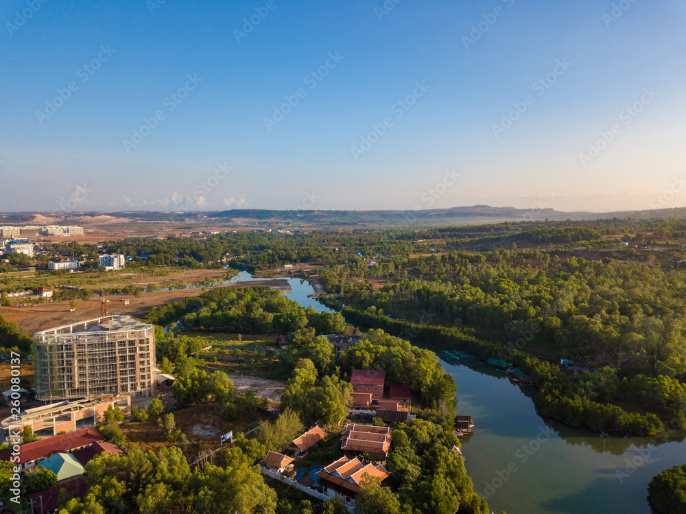 Aerial view of the Ou Trojak Jet river with resorts and boat on riverbank.