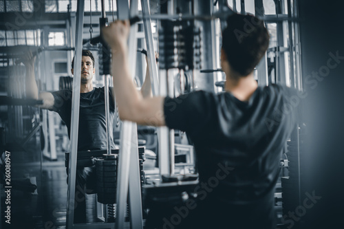 Portrait handsome caucasian young man healthy fitness doing exercise at indoor workout in gym. People beauty perfect body slim fitness man. Freedom happy and relax lifestyle healthcare concept.