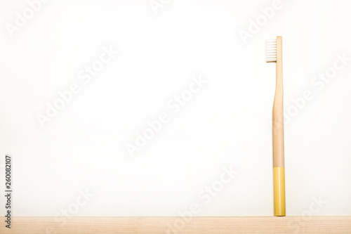 yellow colours bamboo toothbrushes on white background. Place for text. Ecoproduct. eco-friendly.