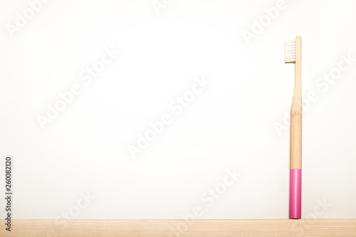 pink colours bamboo toothbrushes on white background. Place for text. Ecoproduct. eco-friendly.