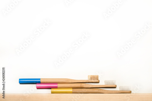 full colours bamboo toothbrushes on white background. Place for text. Ecoproduct. eco-friendly.
