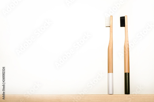 black and white colours bamboo toothbrushes on white background. Place for text. Ecoproduct. eco-friendly.