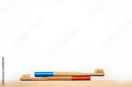 blue and red colours bamboo toothbrushes on white background. Place for text. Ecoproduct. eco-friendly.