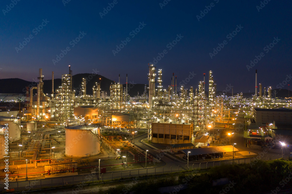 Aerial view. Oil refinery factory and oil storage tank at twilight and night. Petrochemical Industrial.