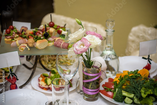 catering table set service with silverware and glass stemware at restaurant before party
