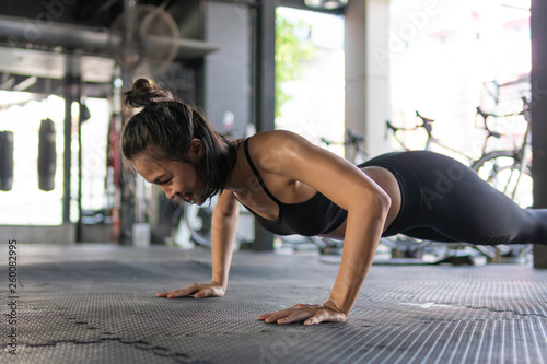 Asian women are exercising in the gym  practicing sports with pushups.