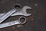 Wrench tools on a concrete floor. Dirty set of hand tools on a vintage background. Tools and wrench. Many old wrench and tools close-up in box.
