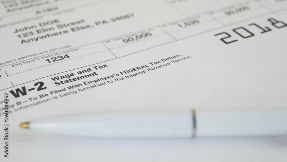 Tax document for the IRS W-2 Tax form on wooden table in office or at home