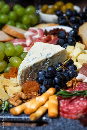 assorted cheeses, fresh fruits and meats, vertical selective focus