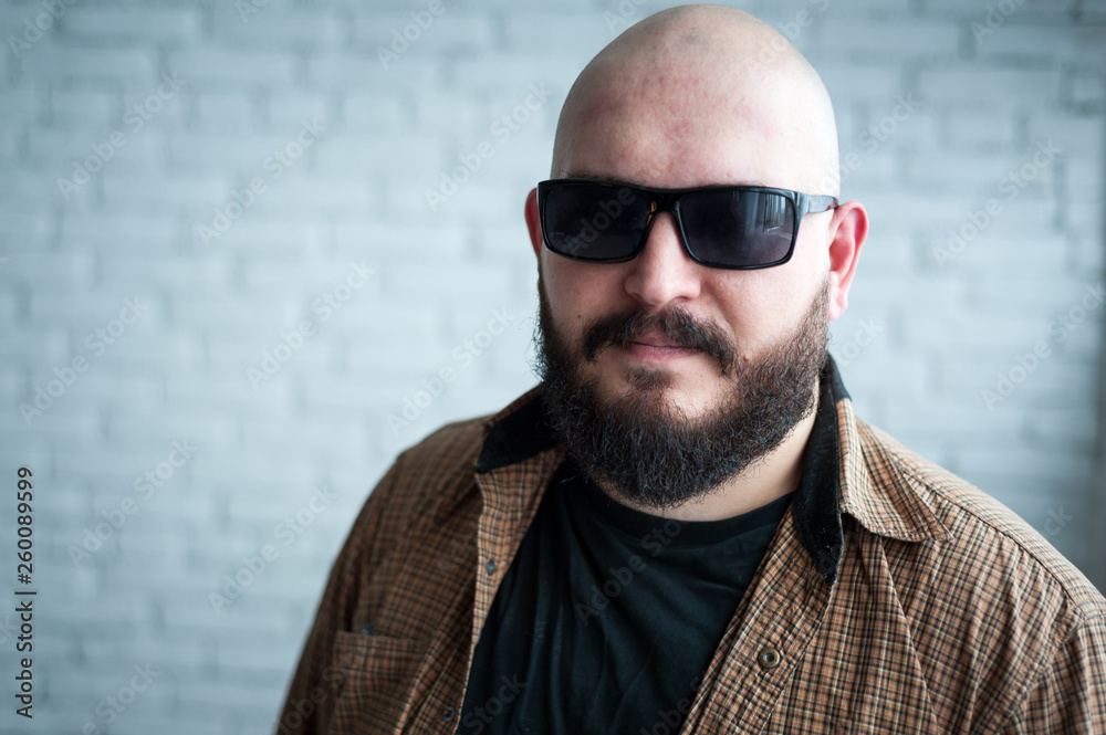Fototapeta premium Portrait of a bald man in a shirt with a beard