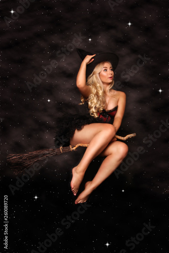Beautiful Blonde Witch on Broomstick Halloween