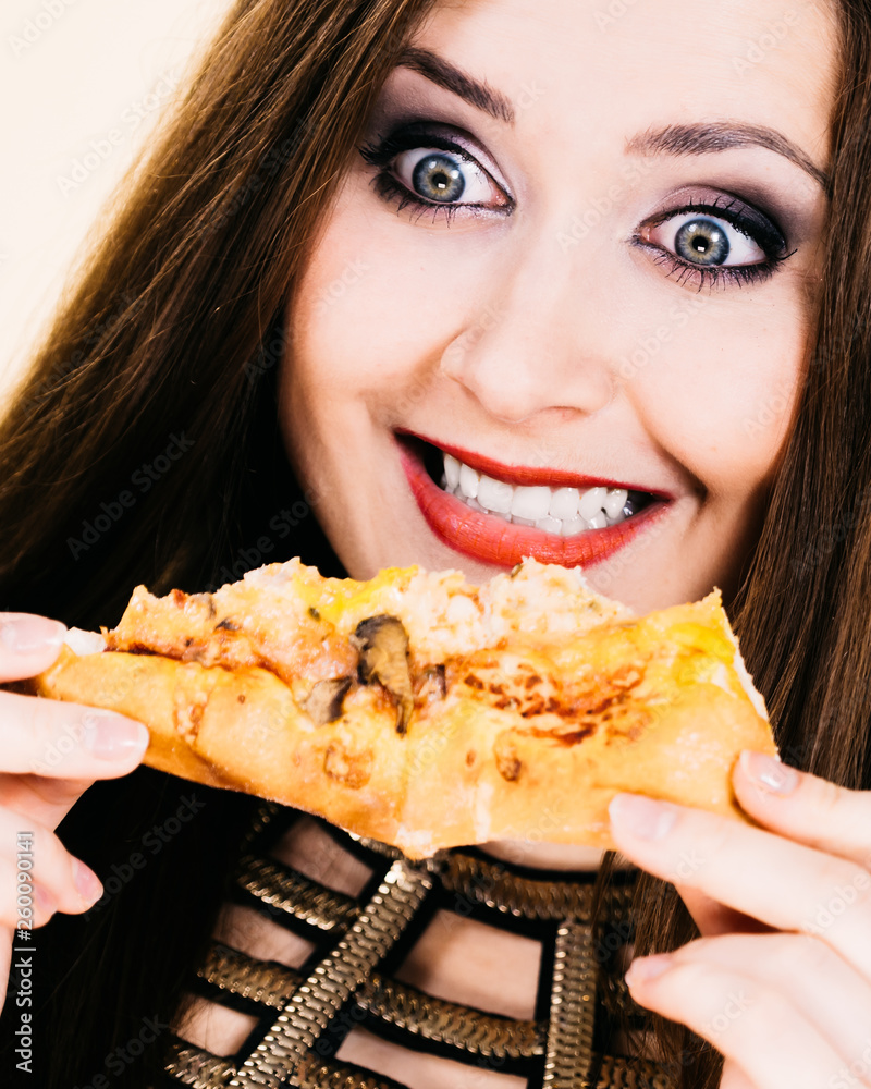 Woman eating hot pizza slice