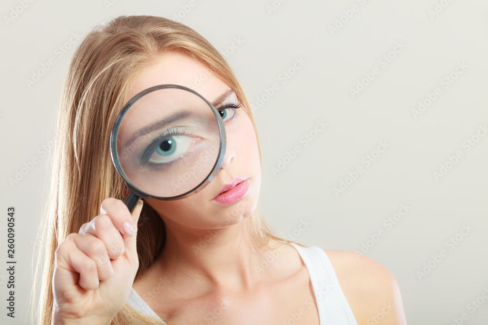 girl holding on eye magnifying glass loupe girl holding on eye magnifying glass loupe