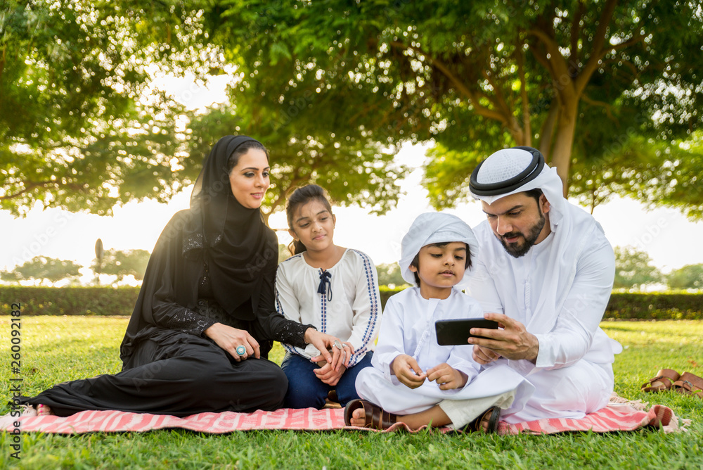 Happy arabian family in a park Happy arabian family in a park