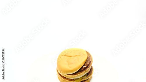 Woman stacking beef burgers on top of one another photo