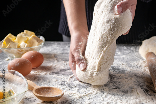 Making dough by female hands at bakery