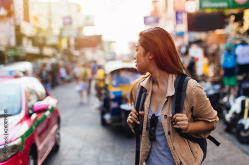 Young Asian female tourist woman walking and backpacking on Khaosan road in Bangkok, Thailand. Travel and Backpack in Asia concept