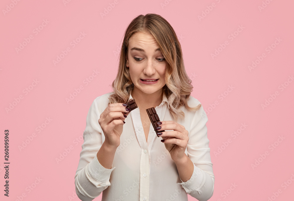 Woman accidentally dividing chocolate Woman accidentally dividing chocolate