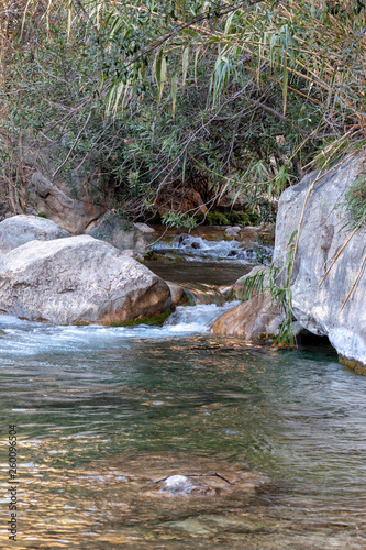 Waterfall with green water pond. Toll del Baladre, Las Fuentes del Algar / Algar fountains, Callosa de Ensarria, Alicante province, Spain.. photo