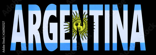 Bold text cutout letters from the image of a national flag with black background. Great photo with graphic elements for any nation specific subject. Argentina flag in blue, white and yellow photo