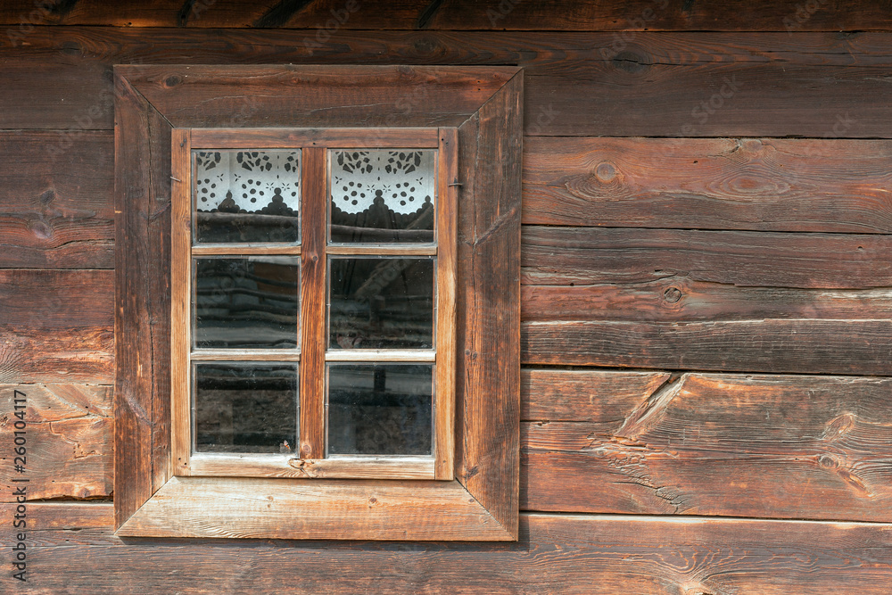 The old window of old wooden house. Background of wooden walls