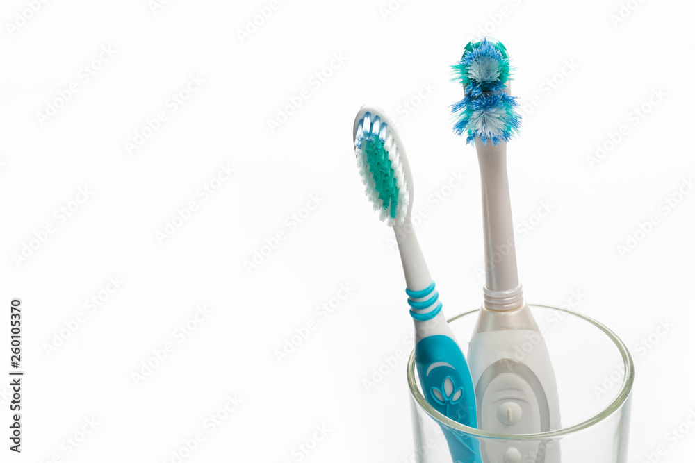 Set of new and old toothbrushes in glass on white background. Set of new and old toothbrushes in glass on white background.