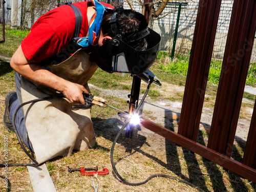 Man is welded to a steel gate metal latch.