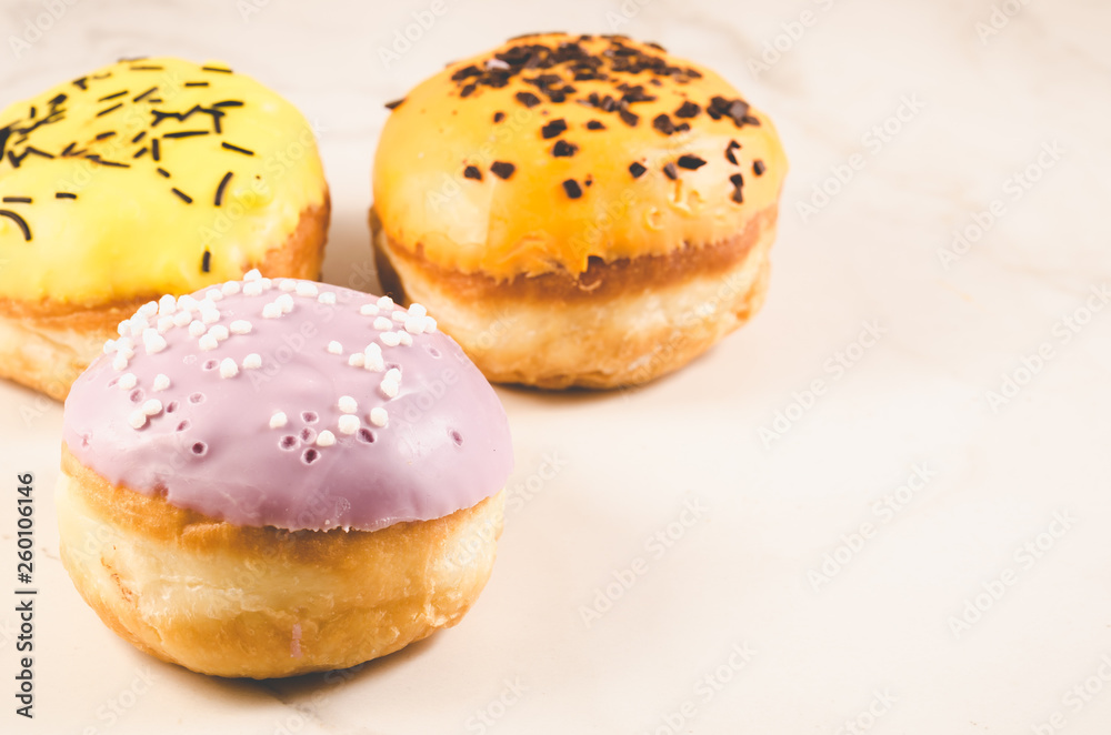 Donuts. Assorted donuts lying on a white table, copy space. Selective focus. Сoncept sweet food. Donuts. Assorted donuts lying on a white table, copy space. Selective focus. Сoncept sweet food.