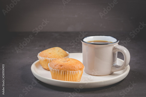 muffins and coffee for breakfast on a white tray