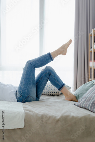 A blonde woman is lying on the bed