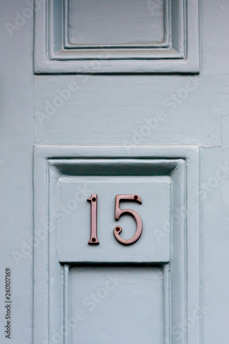 House door number fifteen with the 15 in silvery metal digits