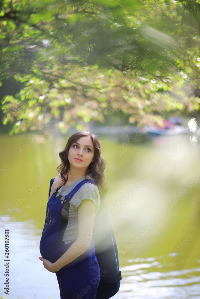 Pregnant woman on a walk in the park Pregnant woman on a walk in the park
