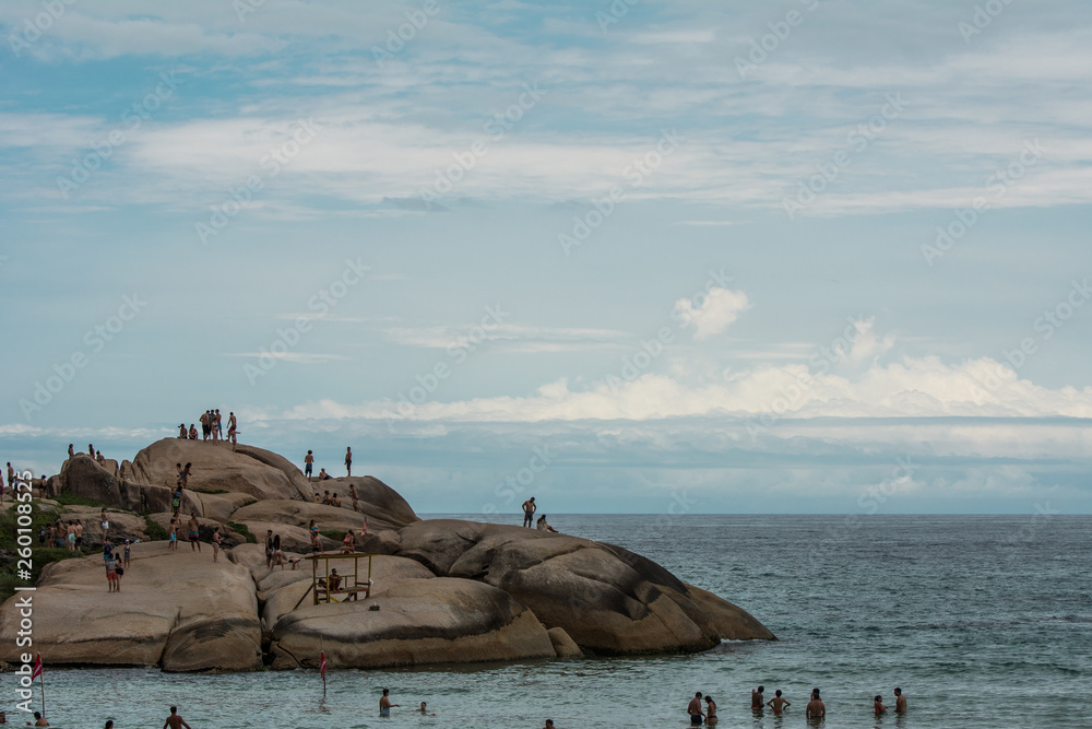 People having fun on the stones at Joaquina Beach, in Florianopolis, Brazil.