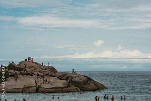 People having fun on the stones at Joaquina Beach, in Florianopolis, Brazil.