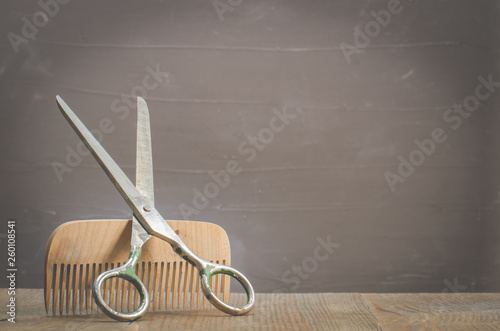 barbershop concept. Old style. Hairbrushes and a scissors on a gray background with copy space. Selective focus
