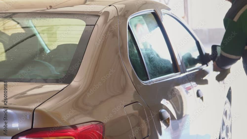 The car is washed with high-pressure water at a car wash The car is washed with high-pressure water at a car wash