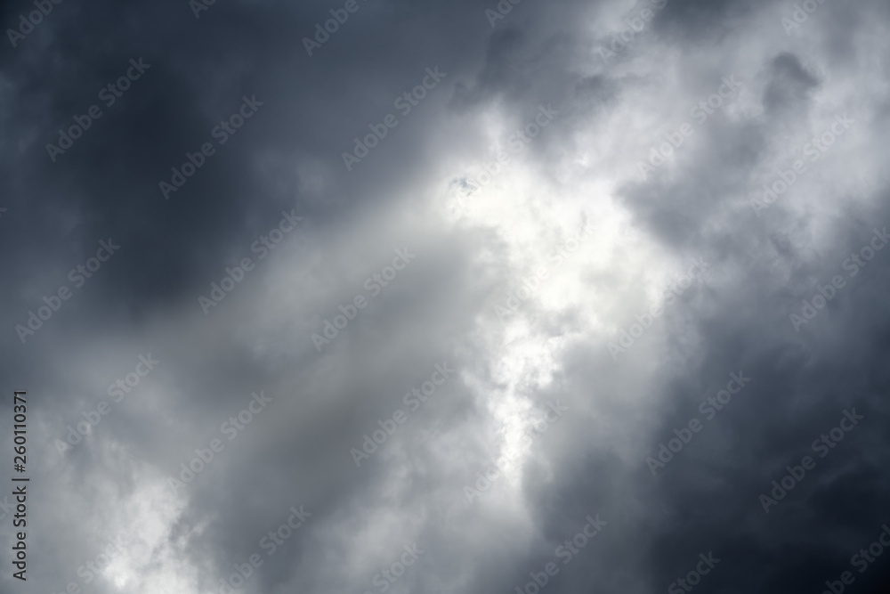 Fototapeta premium Dramatic dark cloudy sky background with beautiful sunbeam