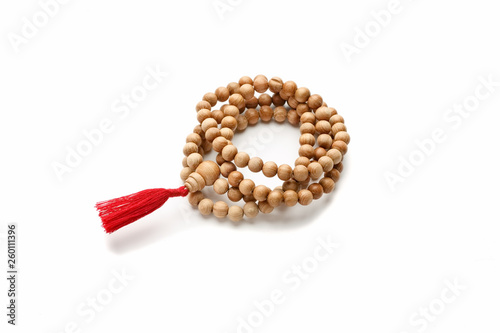 Canvas Print Wooden buddhist rosary with red tassel isolated on white