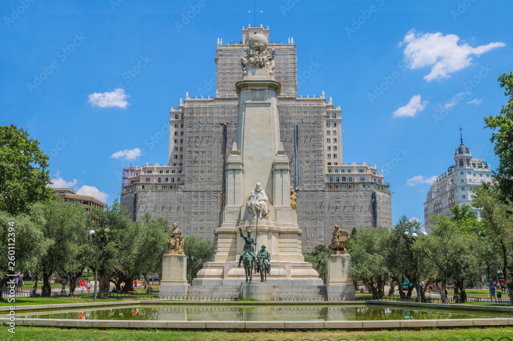 Obraz premium Monumento Cervantes upfront. Behind is the Edificio España under reparations. Shoot in July 2018