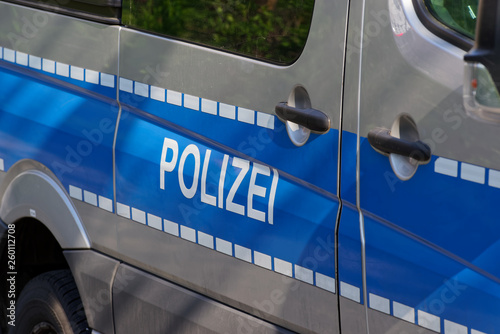 Side view of a typical german police car with lettering "Polizei" on blue background