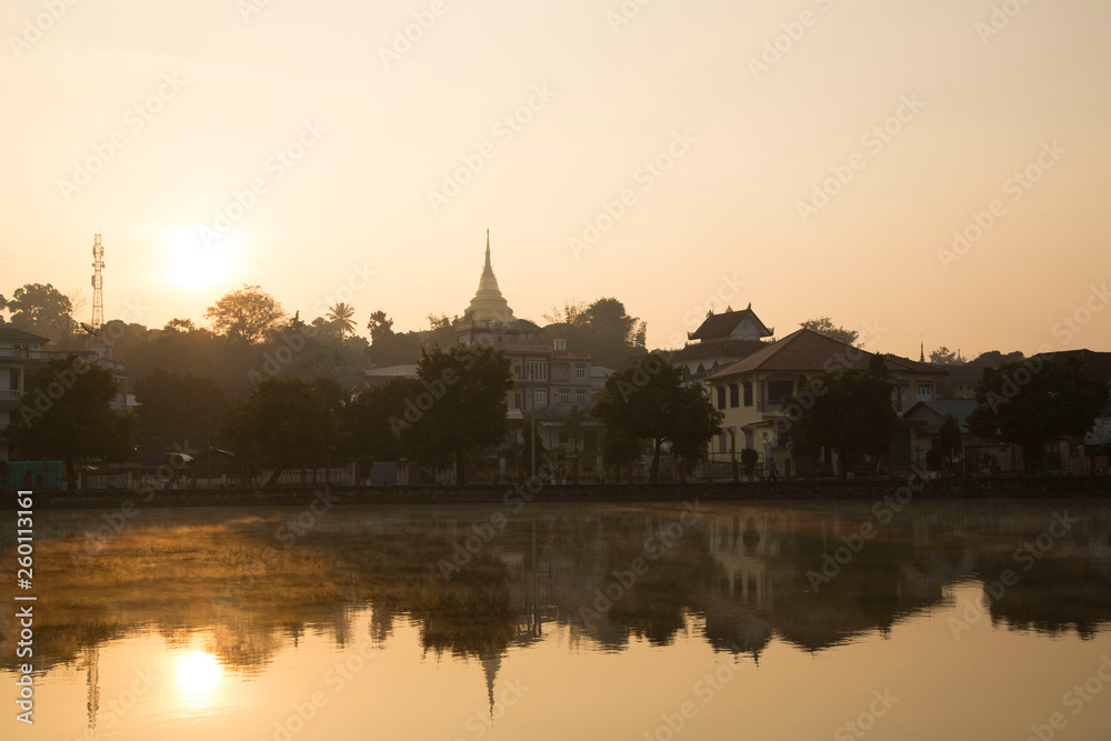 Kengtung at dawn. Beautiful sunrise and the reflection of building around the Tung lake. 