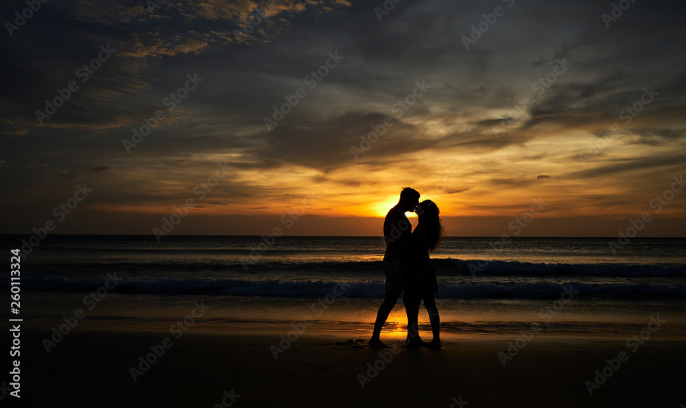 Happy couple on the beach at sunset kissing. Thailand, Phuket Island